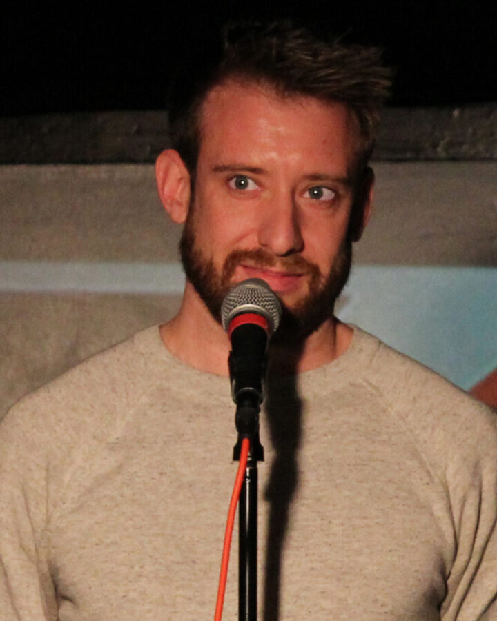 Brennan Keller, Chicago writer and creative director, performing live storytelling on stage